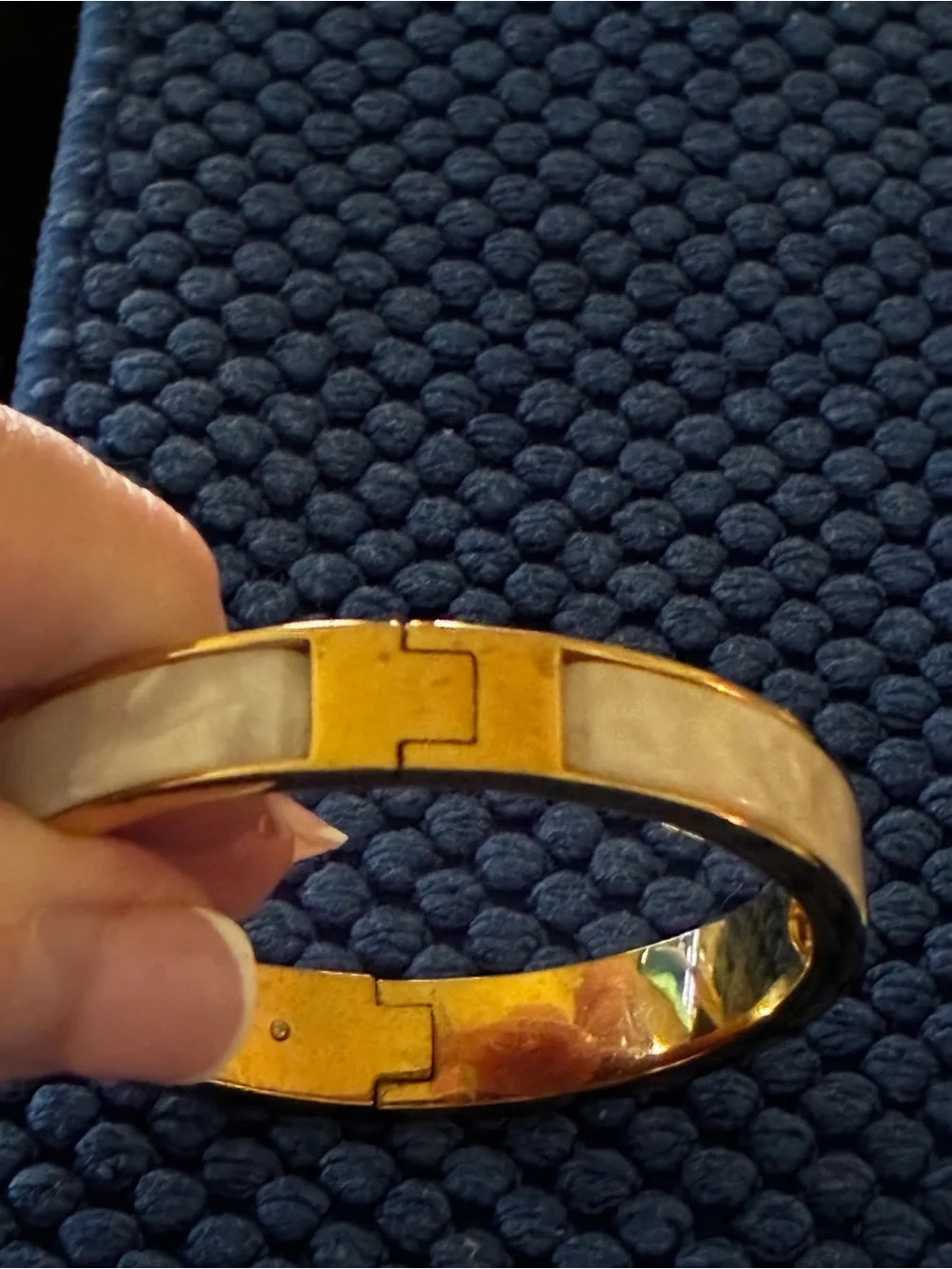 Kate Spade gold-tone bangle with cream enamel and heart detail